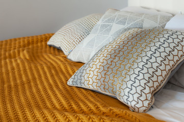 Gorgeous yellow cable knit blanket on bed in cozy bedroom