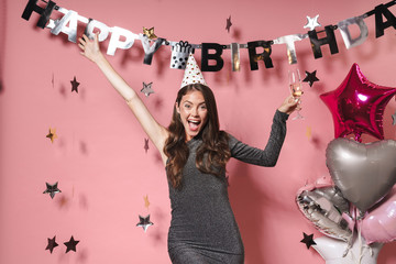 Optimistic beautiful young woman at the happy birthday party