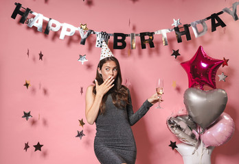 Optimistic beautiful young woman at the happy birthday party