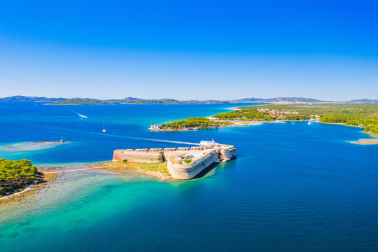 Saint Nicholas fortress and Jadrija town at Sibenik bay entrance, Dalmatia, Croatia, drone aerial shot of beautiful blue coastline seascape