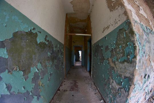 Abandoned places hallway with peeling lead paint  in Russian cold war secret East German town