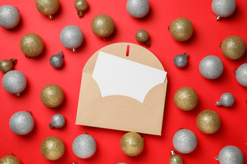 Blank letter and Christmas balls on red background, space for text