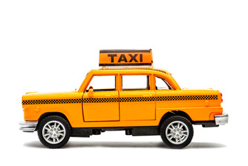 Yellow taxi toy retro car model on a white background. Isolated