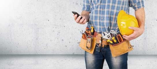 Worker and professional builder with tools