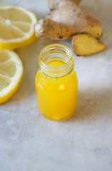 Close up of a small lemon and ginger shot