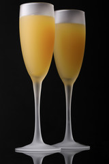 Christmas glasses with apricot liquor, on a dark background