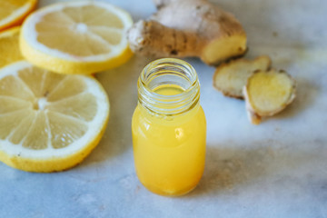 Close up of a small lemon and ginger shot