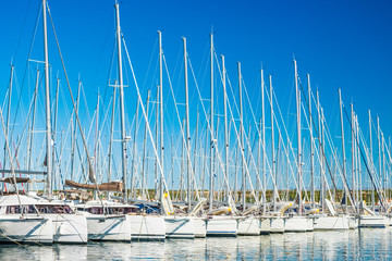 Yachts and sailboats anchored in raw in marina in town of Biograd na Moru, Adriatic sea in Croatia