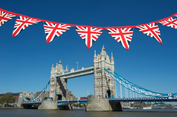 Fototapeta na wymiar Classic blue sky view of Tower Bridge with vintage Union jack bunting in London, UK