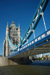 Fototapeta na wymiar Bright sunny daytime view of Tower Bridge with blue sky above the River Thames in London, UK