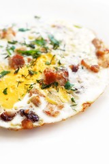 Omelet with eggs, bacon (brisket) and herbs on a white background. Recipe for a healthy diet and breakfast. Close-up.