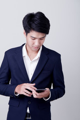 Young asian businessman using a smart phone