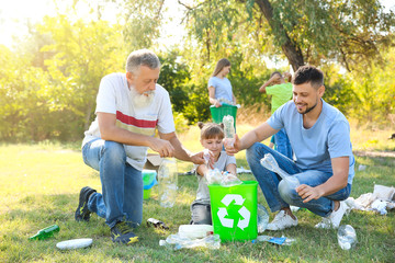 People gathering garbage outdoors. Concept of recycling