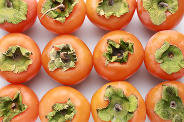 Ripe persimmons on white background