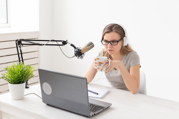 Radio host, streamer and blogger concept - Woman working as radio host at radio station sitting in...