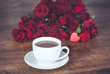red rosses with cup of coffee and heart