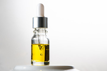 Glass bottle with dropper. Studio. Medical cannabis, essential oils or anti aging serum concept