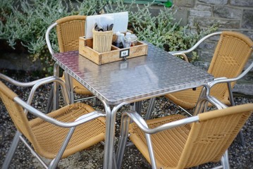 Metal and wicker outdoor cafe table and chairs