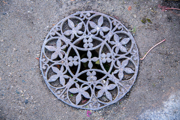 A highly decorative old fashioned drain cover