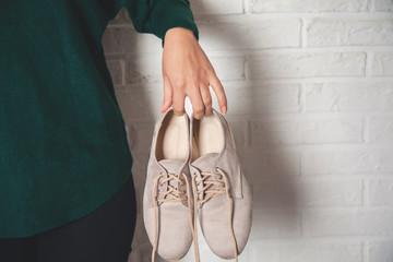 woman hand holding sport shoes