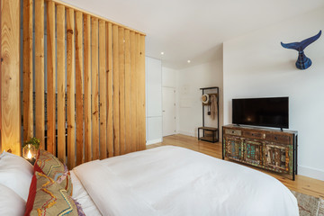 Light modern interior design, studio apartment with kitchen, double bed, big windows and wooden decor