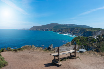 Fototapeta na wymiar bench high on the cliff by the ocean