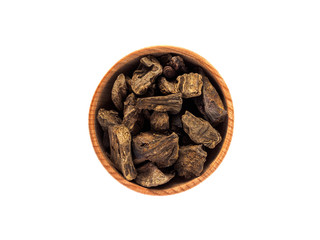 Dry inula root in wooden Cup on white background