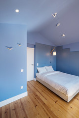Modern apartment interior design in blue colours,  small and cozy bed room