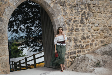 Fototapeta na wymiar Portrait of woman wearing medieval European maidservant clothes on outdoors. Festival in îbidos Portugal