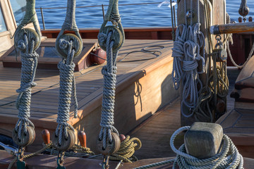 rigging, ropes and knots on a historical wooden sailing ship on a sunny day on the sea
