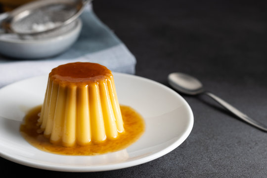 Homemade creme caramel desert on a dark background