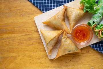 Samosas on wooden board.Top view
