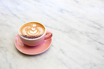 Cup of cappuccino on marble table.