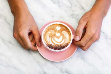 Cup of cappuccino on marble table.