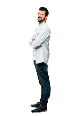 Fototapeta premium Full-length shot of Handsome man with beard with arms crossed and looking forward over isolated white background