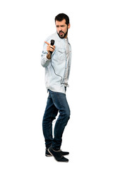 Handsome man with beard singing with microphone