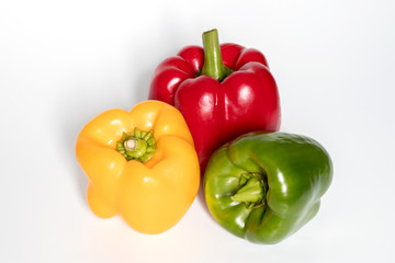 Three Red, Yellow, Green Peppers isolated on white background.