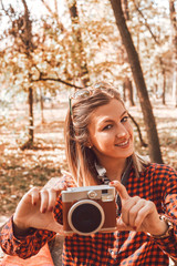 Portrait of beautiful attractive woman enjoying and posing in autumn day.