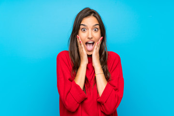 Young woman with red sweater over isolated blue background with surprise facial expression - obrazy, fototapety, plakaty