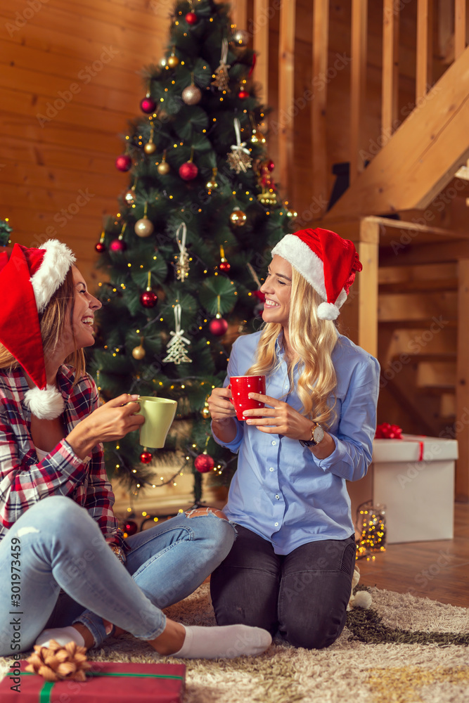 Wall mural Women drinking coffee on Christmas morning