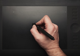 Hand wit pen and  graphic tablet  top view photo