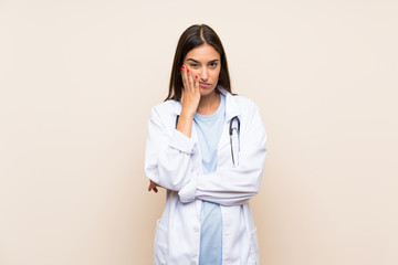 Young doctor woman over isolated background unhappy and frustrated