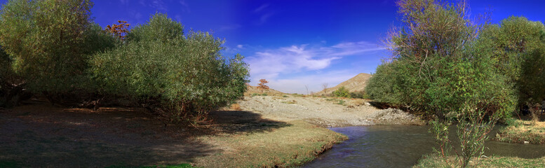 Fototapeta na wymiar Panoramic wide angle view landscape view of a mountain river in Turkmenistan, Central Asia