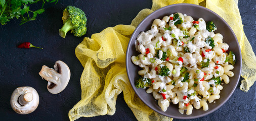Cavatappi pasta with broccoli, red pepper and cream sauce in a bowl. Vegetarian dish. Delicious...