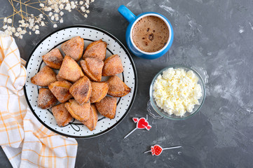 Tasty curd cheese cookies on a plate. Goose foot cookies. Homemade cakes and coffee for breakfast.