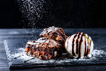 hot chocolate brownie dessert ice cream ball and slice of chocolate cake - Powered by Adobe