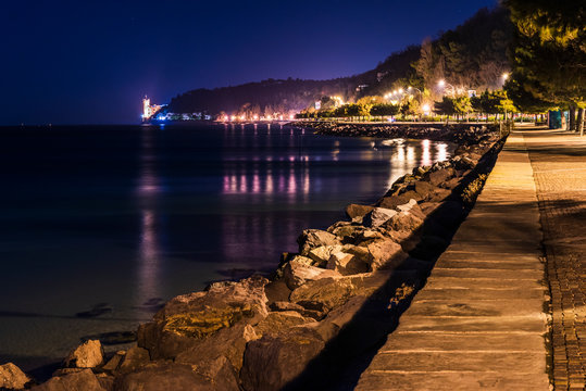 Promenade of Barcola, towards the castle of Miramare. Atmospheric lights in Trieste. Italy