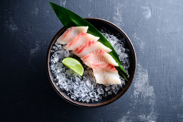 Sashimi Japanese food, slices of sashimi perch on ice. Sliced fish in an expensive restaurant - obrazy, fototapety, plakaty