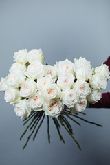 Close-up of white roses. A girl holding a rose. Flowers