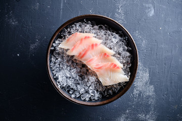 Sashimi Japanese food, slices of sashimi perch on ice. Sliced fish in an expensive restaurant - obrazy, fototapety, plakaty
